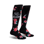 Pair of black knee-high socks with red and pink roses and the phrase 'Stop & Smell the Roses'.