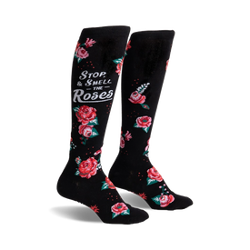 black knee-high socks with a floral pattern of red, pink, and white roses and the message "stop and smell the roses" in white script.  