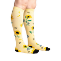 Lifestyle shot: Person wearing the sunflower knee-high socks, showing the design on the legs.