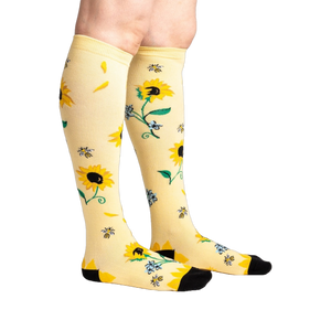 Lifestyle shot: Person wearing the sunflower knee-high socks, showing the design on the legs.