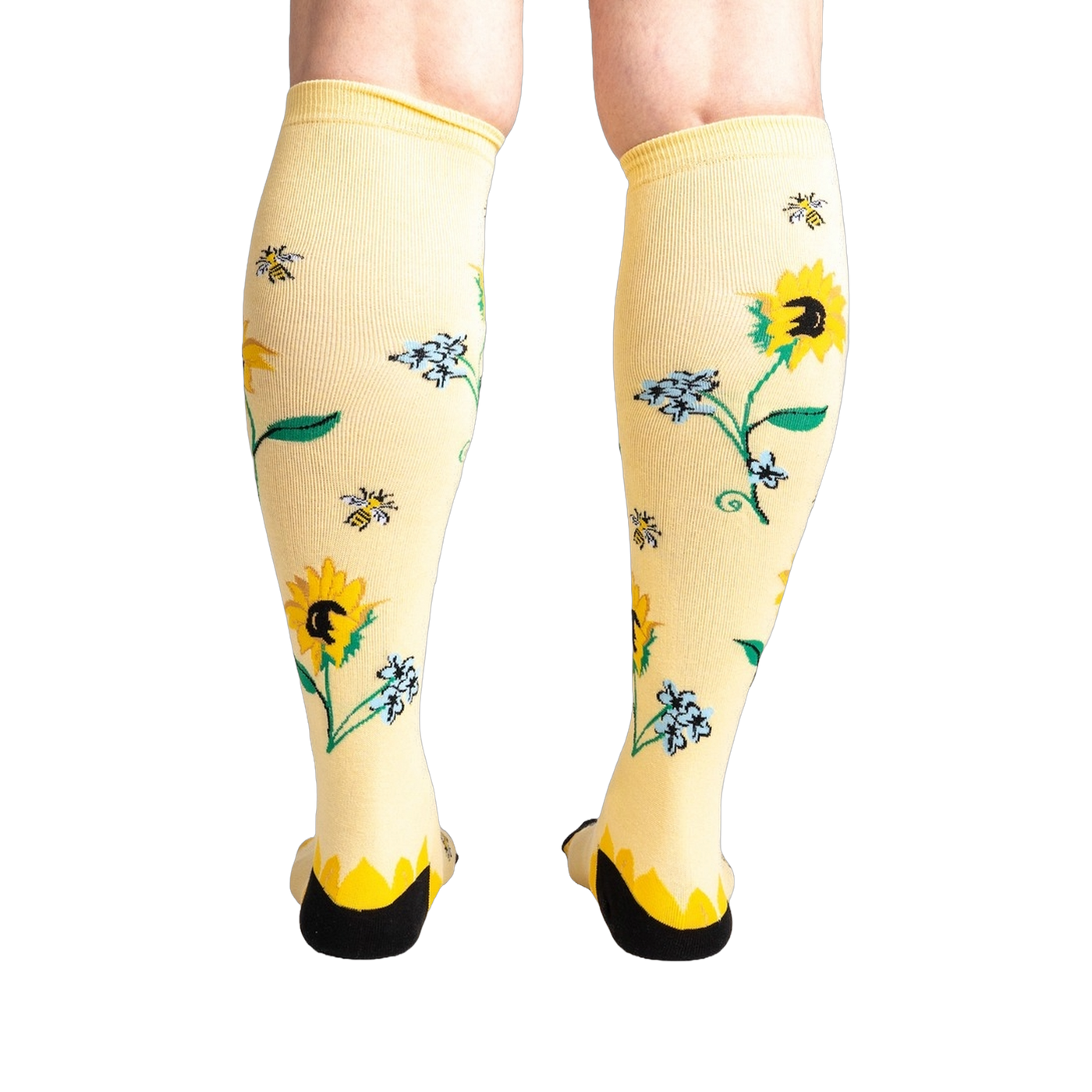 Rear view of the socks on a person's legs, showcasing the back of the sunflower design.