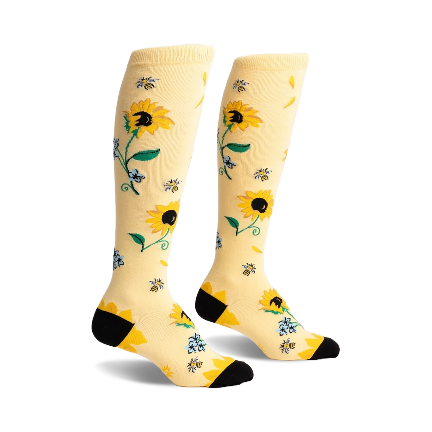 Pair of knee-high socks in pale yellow with a sunflower, bee, and floral design. Black heel and toe.