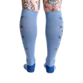Back view of the light blue knee-high socks showcasing the full design featuring butterflies and ladybugs.