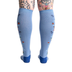 Back view of the light blue knee-high socks showcasing the full design featuring butterflies and ladybugs.