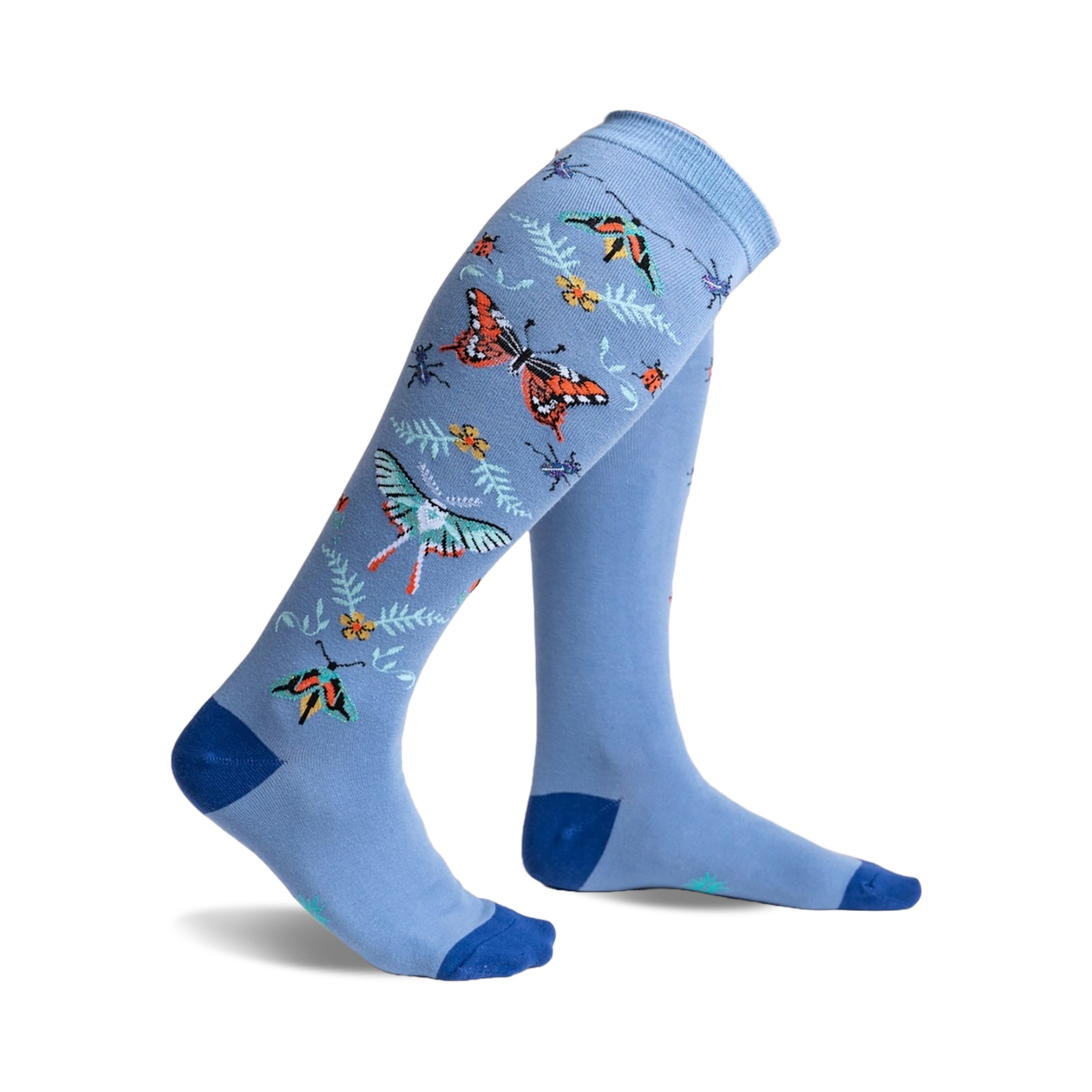 A pair of light blue knee-high socks adorned with colorful butterflies, ladybugs, and floral accents. 