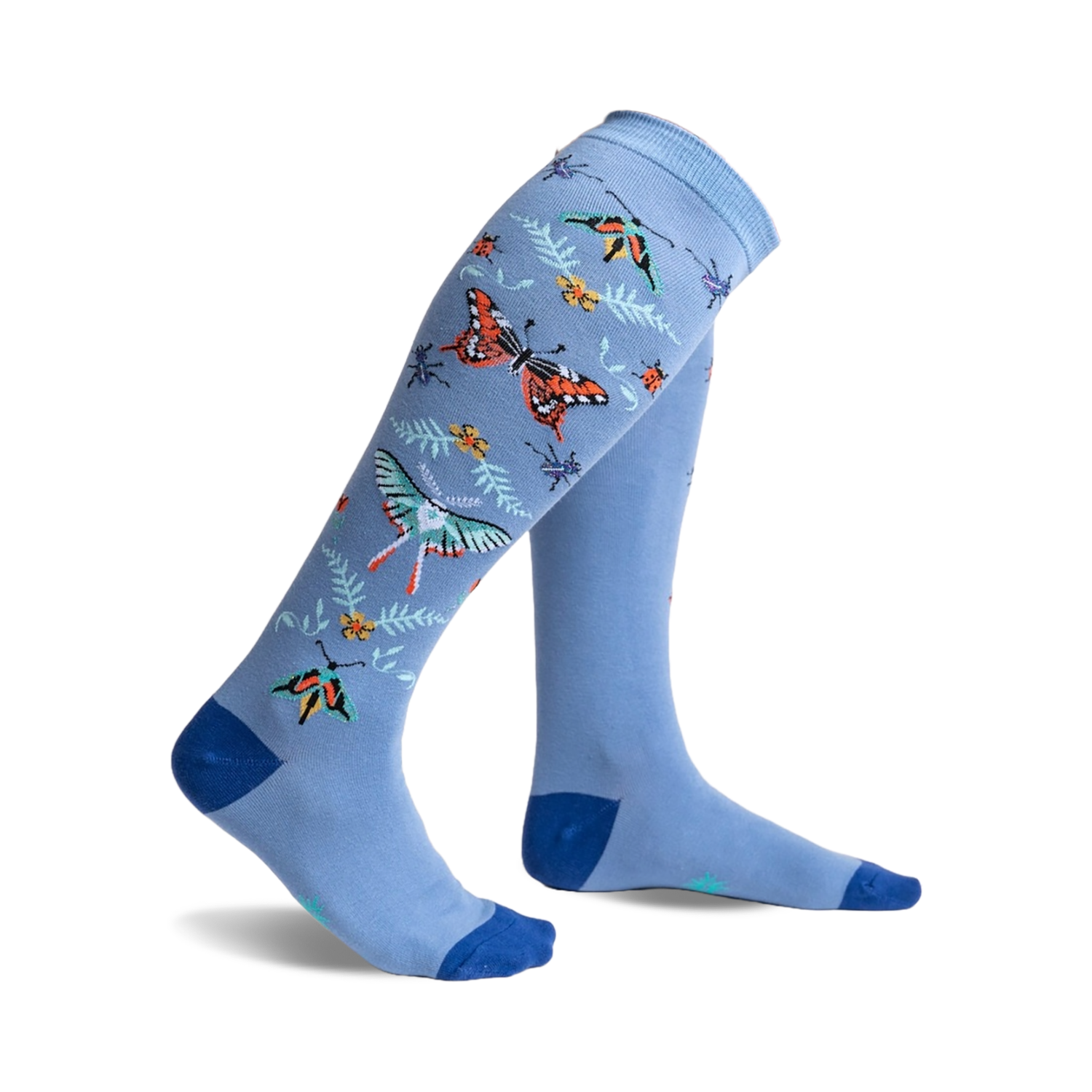 A pair of light blue knee-high socks adorned with colorful butterflies, ladybugs, and floral accents. 