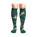 Close-up of a person's legs wearing the Flying Cranes knee-high socks; showcasing the full design on the legs.