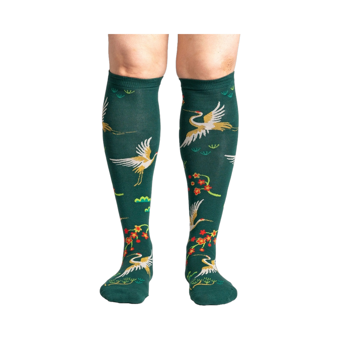 Close-up of a person's legs wearing the Flying Cranes knee-high socks; showcasing the full design on the legs.