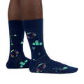 Lifestyle shot of the socks glowing in the dark, highlighting the luminescent design elements.
