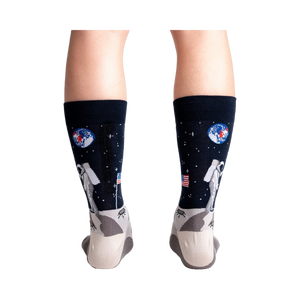 Rear view of a person wearing the 'High-est 5' socks, showcasing the full design on both socks.