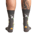 Back view of the Weird Science socks on a model, showing the full design on both socks.
