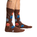 Lifestyle shot of a man's legs wearing the brown yo-yo socks.