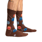 Lifestyle shot of a man's legs wearing the brown yo-yo socks.