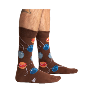 Lifestyle shot of a man's legs wearing the brown yo-yo socks.