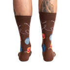 Rear view of a man's legs wearing the brown yo-yo socks.