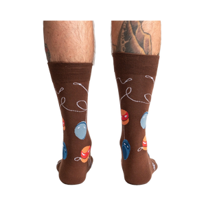 Rear view of a man's legs wearing the brown yo-yo socks.