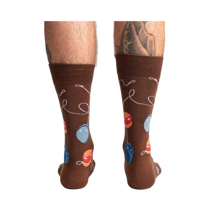 Rear view of a man's legs wearing the brown yo-yo socks.