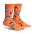 Pair of orange crew socks featuring a repeating pattern of chickens skateboarding.  The chickens wear shades and red combs.