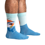 Lifestyle shot of a person wearing the teal and light blue shark socks.