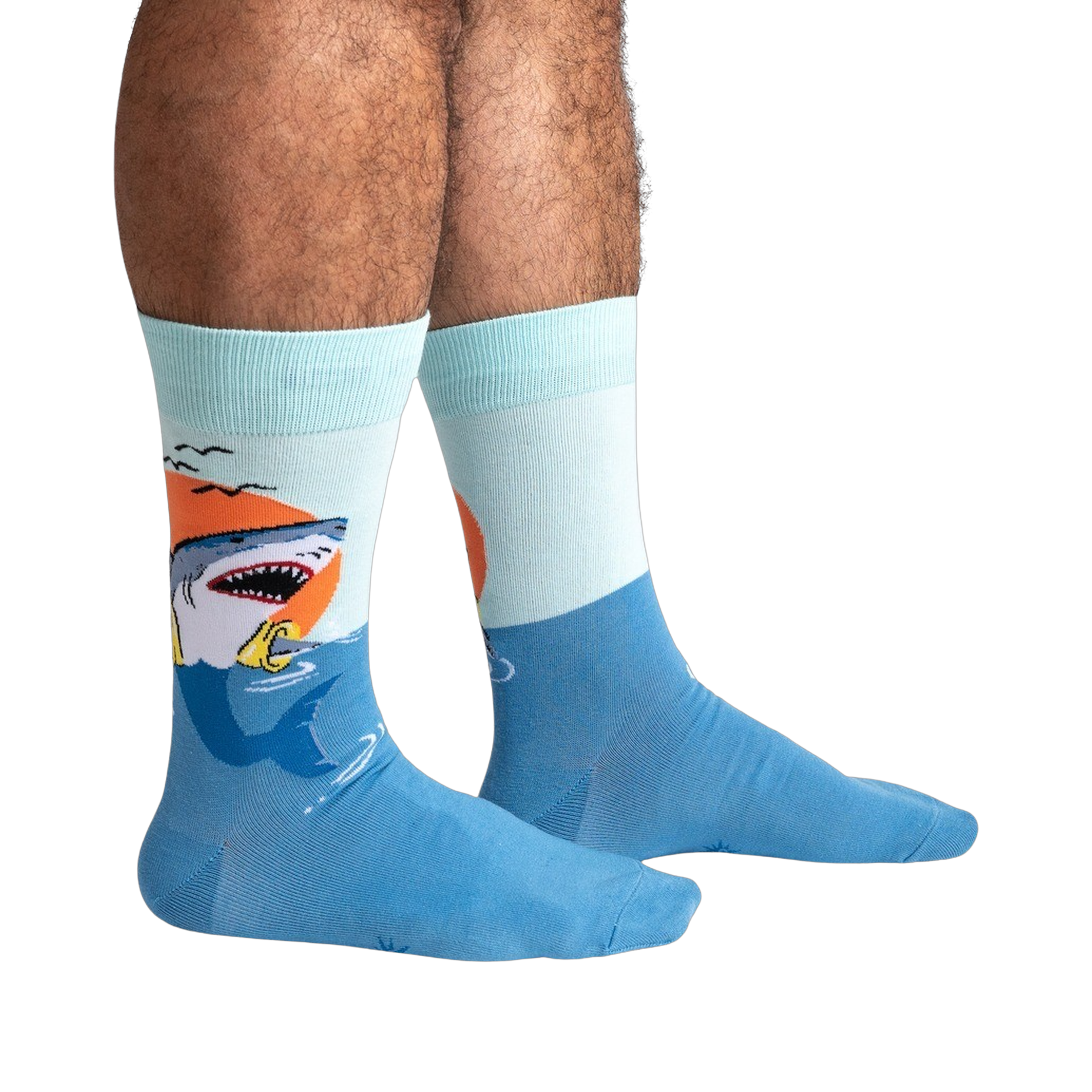 Lifestyle shot of a person wearing the teal and light blue shark socks.