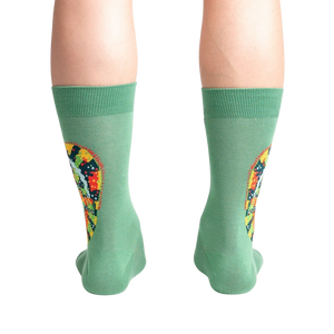 A pair of green socks with a colorful pattern on the back of the calf.