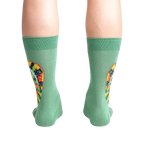 Rear view of a person wearing the socks, highlighting the full chameleon design on the back of the socks.