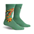 Pair of sage green crew socks with a colorful chameleon design. The chameleon is orange, yellow, and black.