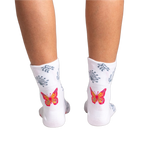 Close-up detail shot of a vibrant orange and pink butterfly design on the sock.