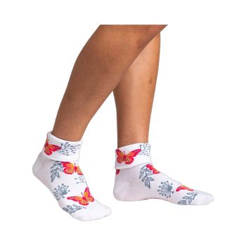 Women's white ankle socks with a turn-cuff, featuring orange and pink butterflies and gray floral designs.