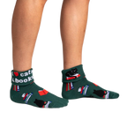 Lifestyle photo showcasing the 'I Love Cats & Books' socks on a person's feet.