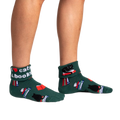 A pair of women's dark green turn-cuff socks. The socks are adorned with illustrations of black cats reading books, stacked books, and mugs.  Text reads 'I love cats & books'.