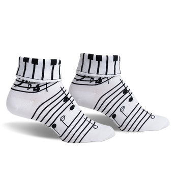 pair of white socks with black piano keys and musical notes on the top of the sock and music notes on the rest of the sock. front view of the socks.