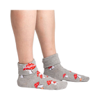 Lifestyle shot showing the socks on a person's legs, showcasing the fit and style of the 'Magical! Turn Cuff' socks.