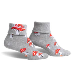 pair of grey socks with a glitter finish and red and white mushroom designs. the socks have the word 