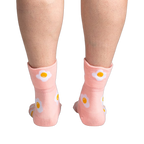 Back view of the socks on a person's legs, highlighting the design on the back of the socks.