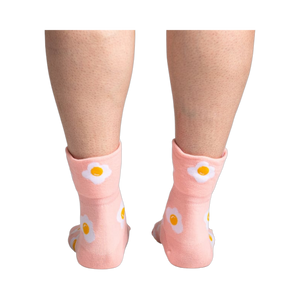 Back view of the socks on a person's legs, highlighting the design on the back of the socks.
