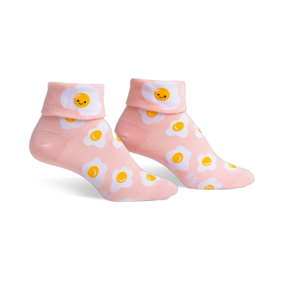 Pair of pink ankle socks featuring a whimsical all-over print of smiling fried eggs.  The socks have a folded-over cuff.