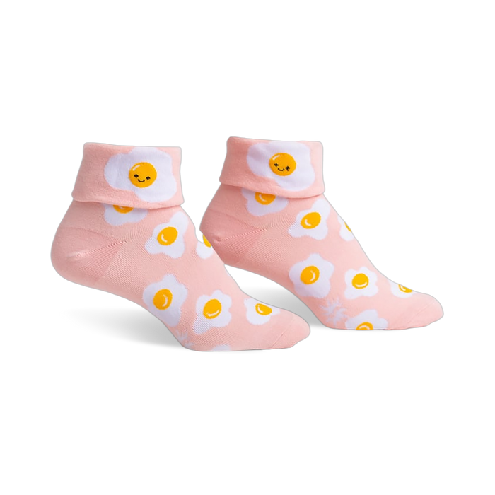 Pair of pink ankle socks featuring a whimsical all-over print of smiling fried eggs.  The socks have a folded-over cuff.