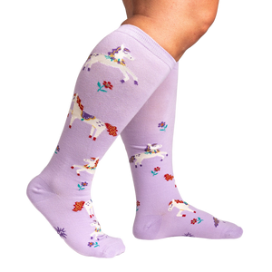 Lifestyle shot showing the lavender unicorn socks on a person's legs, highlighting the extra stretch.