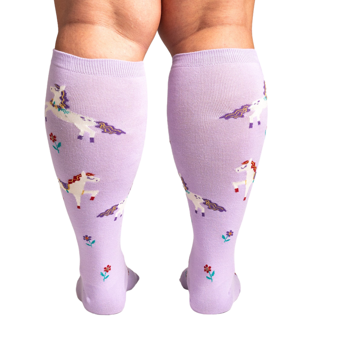 Back view of the socks on a person's legs, showing the full design and fit of the lavender unicorn knee-highs.
