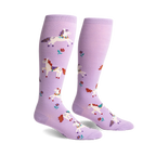 Pair of lavender knee-high socks with a whimsical design of prancing white unicorns and small flowers.
