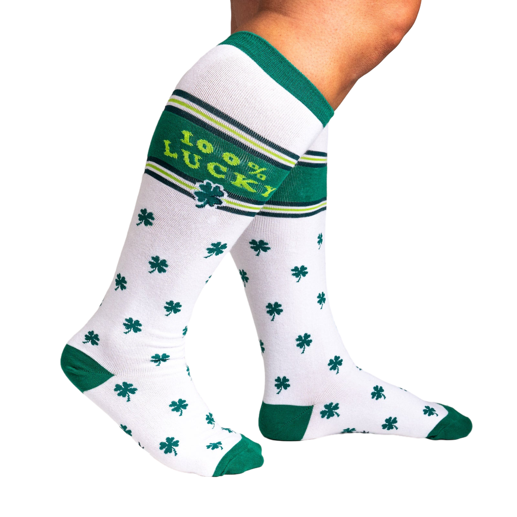 Lifestyle shot showing a person's legs wearing the '100% Lucky' knee-high socks, highlighting their fit and stretch.