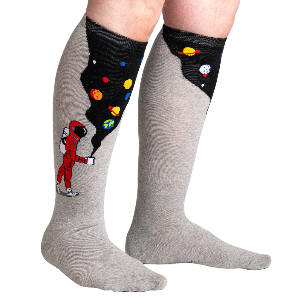 Lifestyle shot of the 'Moon Walk in the Morning' socks on a person's legs, highlighting the extra stretch.