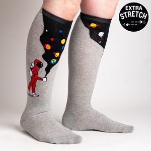 Lifestyle shot of the 'Moon Walk in the Morning' socks on a person's legs, highlighting the extra stretch.