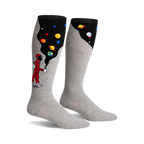 Pair of grey knee-high socks. One side features a cartoon astronaut, planets, and a black space-like design, the other side is solid grey.