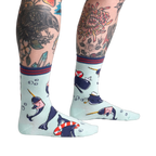 Lifestyle photo showing Whale-y Good Time socks on a model's legs, showcasing the sock's design and fit.