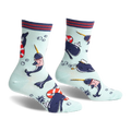 Crew socks featuring narwhals in sailor outfits, life preservers, and paper boats on a light blue background. Red, navy, and white details.