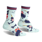 Crew socks featuring narwhals in sailor outfits, life preservers, and paper boats on a light blue background. Red, navy, and white details.