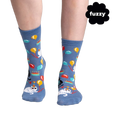 Lifestyle shot showing the socks on a person's feet. The socks are blue with a cat design.