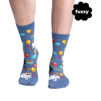 Lifestyle shot showing the socks on a person's feet. The socks are blue with a cat design.